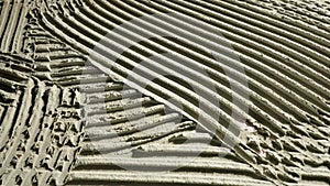 Camera movement by fresh concrete tehture with patterns of notched trowel. Macro shot of grey surface cement putty on