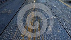 Camera moves along aged wooden boards, painted in navy blue