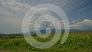 Camera Moves along Farm Fields against Sky in Vietnam