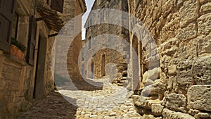 Camera moves along stones street of old town of Lacoste. Walk through picturesque village of Lacoste, Petit Luberon