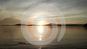 Camera moves along tropical island surf strip at sunset.Bright sunrise over the sea and islands ,Lombok, Indonesia