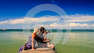 Camera Moves Blond Girl Guy Sit on Pier she Burns he Photos