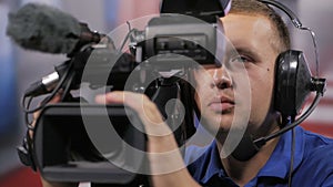 Camera operator working with a cinema broadcast TV camera