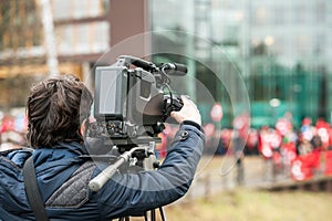 Camera operator working outside during breaking news live event photo