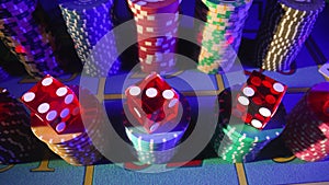 Camera pans over a gaming table with cards, stacks of chips, dice and a dealer chip. Close up of a poker set in a casino