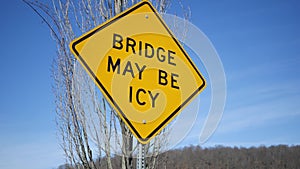Camera pans to a bridge may be icy sign in winter in North America afternoon