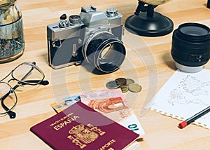Camera, passport, money, glasses, notebook with world map, lens and world globe. Travel concept image: traveler accessories
