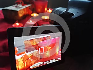 Camera screen with picture present candle