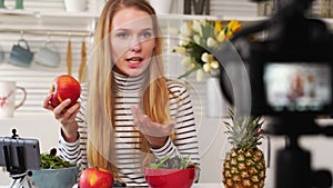 Camera screen recording - focus transition - Food blogger cooking fresh vegan salad of fruits in kitchen studio, filming