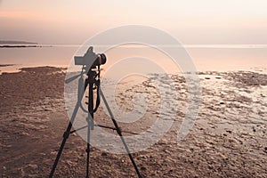 Camera setting at tripod to take photo or video of sunrise or sunset moment