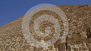 Camera slowly ascends with the awe-inspiring Great Pyramids of Giza.