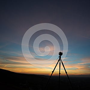 Camera on tripod in sunset
