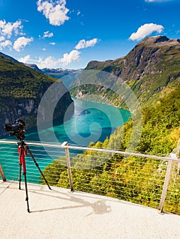 Camera on tripod taking fjord photo, Norway