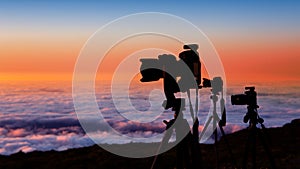 Camera tripods photographer sunset sea of clouds