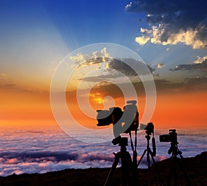 Camera tripods photographer sunset sea of clouds photo