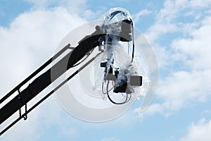 Camera under cover on crane or jib photo