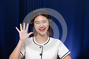 Camera view of Happy young asian business woman wears headset talk to online video conference call with her business team