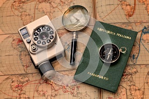 Travel, adventure with camera vintage, passport, compass and magnifier onto a retro world atlas