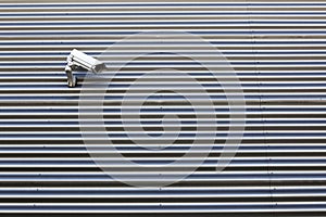 Camera on wall of corrugated iron building