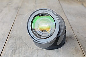 Camera zoom len on wooden table