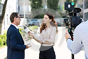 cameraman and anchorwoman with microphone