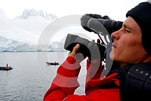 Cameraman filming an iceberg