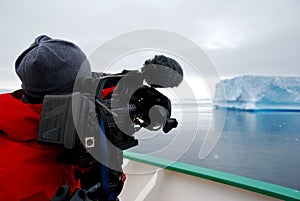 Cameraman filming an iceberg