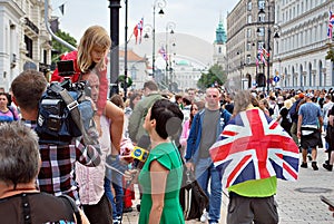 The cameraman filming outdoor event. TVN reporter