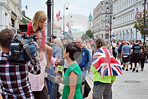 The cameraman filming outdoor event. TVN reporter