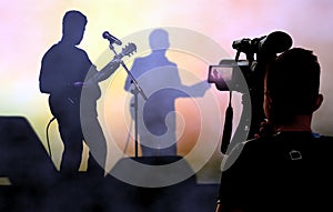 Cameraman recording and broadcasting live on concerts using video camera photo