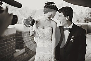 A cameraman shoot a smiling wedding couple