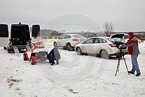Cameraman shoots man prepares buggy car for photo