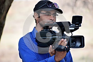 Cameraman using a professional camcorder outdoor