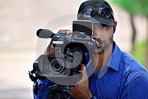 Cameraman using a professional camcorder outdoor