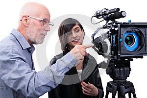 Cameraman and a young woman with a movie camera DSLR on white