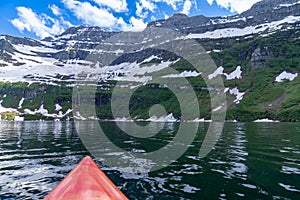 Cameron Lake in Waterton Lakes National Park, as seen from a red kayak, in Alberta Canada photo