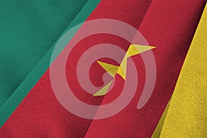 Cameroon flag with big folds waving close up under the studio light indoors. The official symbols and colors in banner