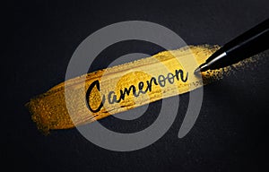 Cameroon Handwriting Text on Golden Paint Brush Stroke