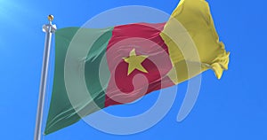 Cameroonian flag waving at wind in slow with blue sky, loop