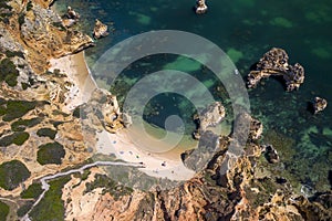 Camilo Beach in Lagos, Algarve - Portugal. Portuguese southern golden coast cliffs. Sunny day aerial view