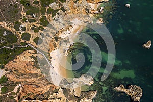 Camilo Beach in Lagos, Algarve - Portugal. Portuguese southern golden coast cliffs. Sunny day aerial view