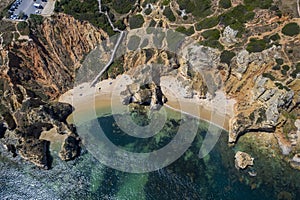 Camilo Beach in Lagos, Algarve - Portugal. Portuguese southern golden coast cliffs. Sunny day aerial view