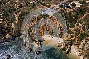 Camilo Beach in Lagos, Algarve - Portugal. Portuguese southern golden coast cliffs. Sunny day aerial view