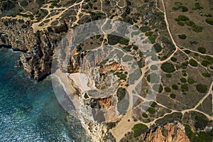 Camilo Beach in Lagos, Algarve - Portugal. Portuguese southern golden coast cliffs. Sunny day aerial view