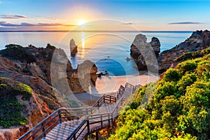 Camilo Beach (Praia do Camilo) at Algarve, Portugal with turquoise sea in background. Wooden footbridge to beach Praia photo