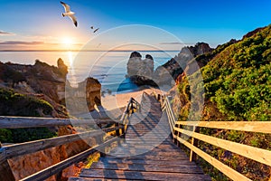 Camilo Beach (Praia do Camilo) at Algarve, Portugal with turquoise sea in background. Wooden footbridge to beach Praia do Camilo,