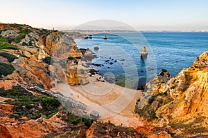 Camilo Beach (Praia do Camilo) at Algarve, Portugal with turquoise sea in background. Wooden footbridge to beach Praia do Camilo,