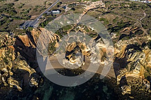 Camilo Beach at sunrise. Lagos, Algarve - Portugal. Portuguese southern golden coast cliffs. Sunny day aerial view