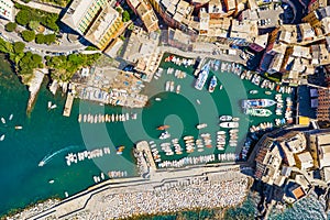 Camogli Marina aerial view. Boats and yachts moored in harbor with green water. A lot fo colorful buildings