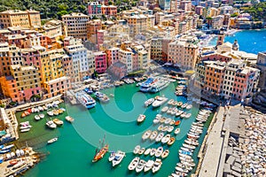 Camogli Marina aerial view. Boats and yachts moored in harbor with green water. A lot fo colorful buildings